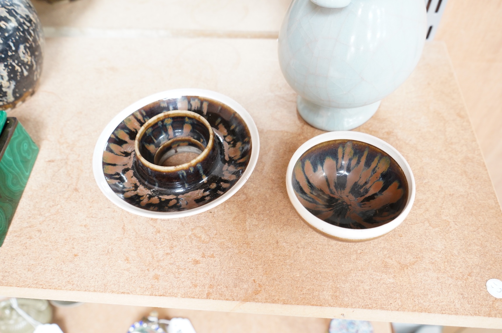 A Chinese crackle glaze arrow vase and a black and russet glazed tea bowl on stand, largest 22cm high